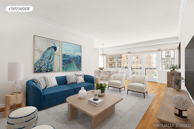 living room with crown molding, a chandelier, and light hardwood / wood-style floors