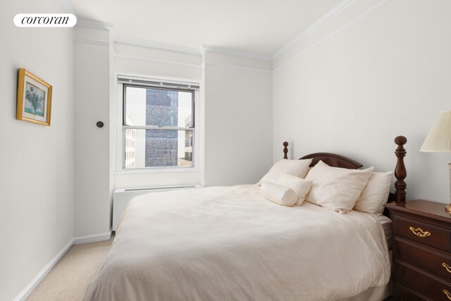 carpeted bedroom with ornamental molding