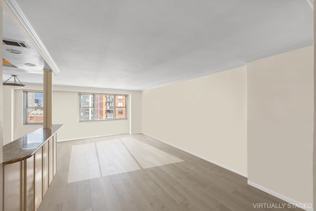 300 E 40th St Unit 31S, New York City, NY 10016 - empty room with crown molding, decorative columns, wood finished floors, and baseboards