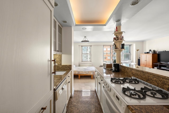 300 E 40th St Unit 31S, New York City, NY 10016 - kitchen featuring granite tiled floors, a sink, white appliances, open floor plan, and a raised ceiling