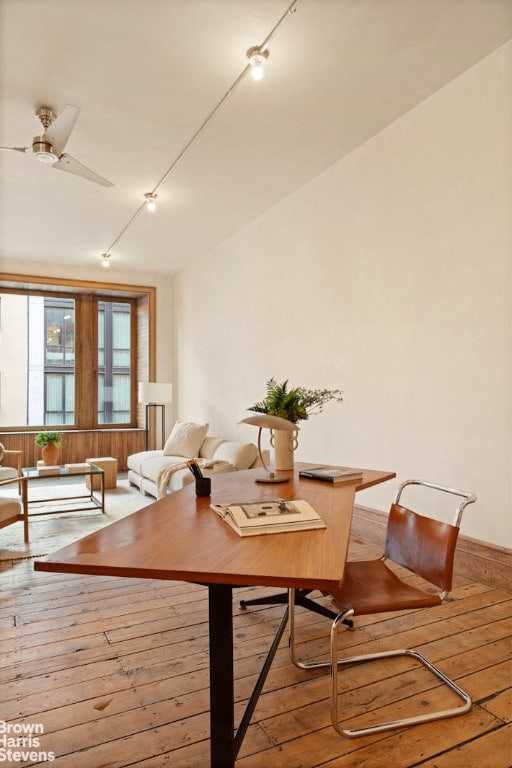 dining area with wood-type flooring and ceiling fan