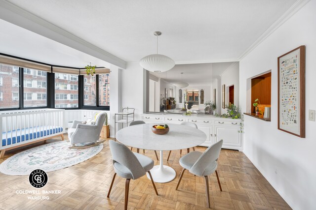 dining area with ornamental molding and light parquet floors