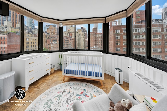 bedroom with a city view and radiator heating unit