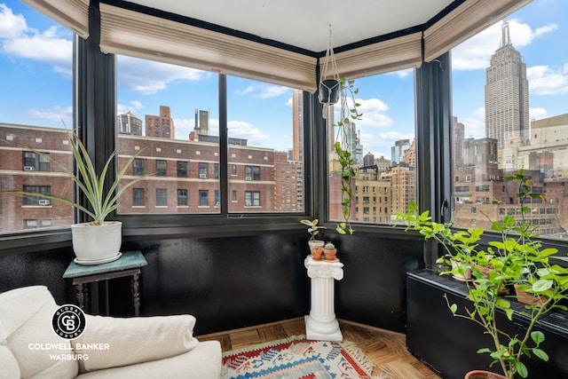 sitting room with a healthy amount of sunlight and a city view