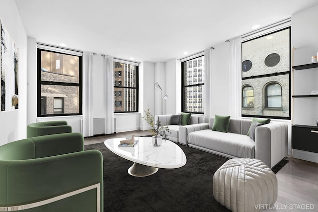 25 Broad St Unit 20-S, New York City, NY 10004 - living area with wood finished floors, healthy amount of natural light, recessed lighting, and baseboards