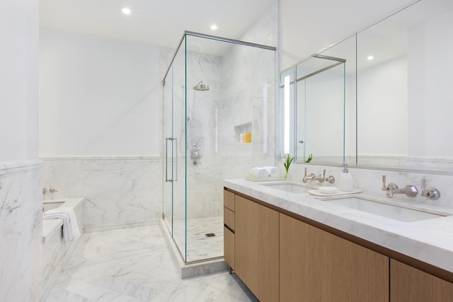 bathroom featuring marble finish floors, a marble finish shower, a garden tub, recessed lighting, and double vanity