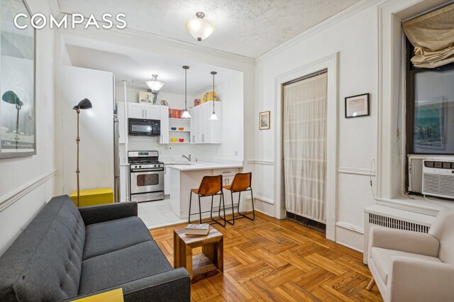 living room with crown molding, sink, light parquet floors, and a textured ceiling