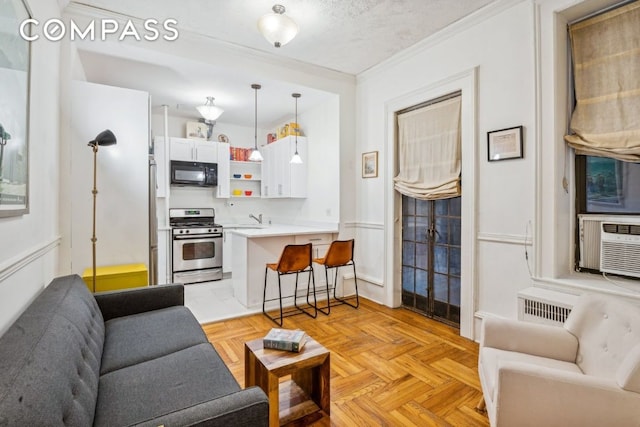 living room with sink, crown molding, cooling unit, a textured ceiling, and light parquet flooring