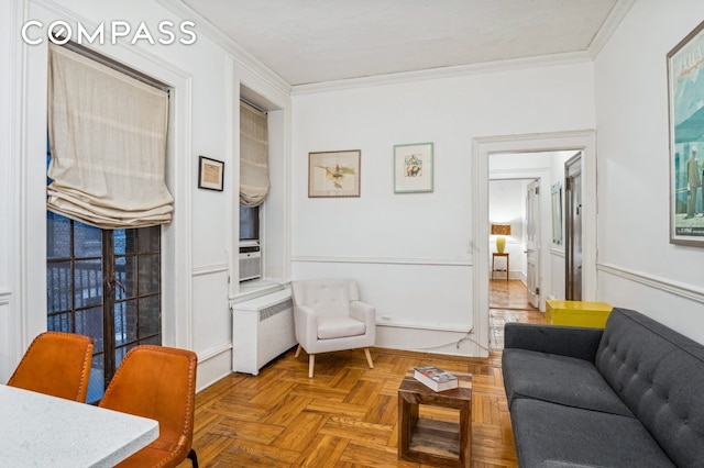 living room featuring crown molding and radiator heating unit