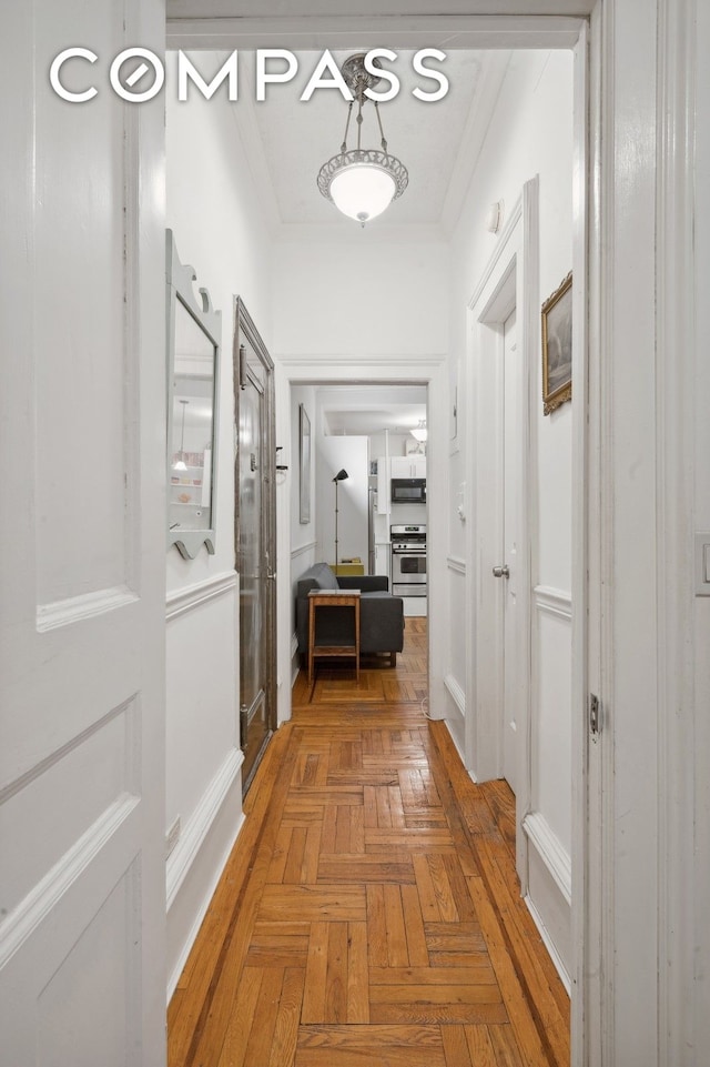 corridor featuring crown molding