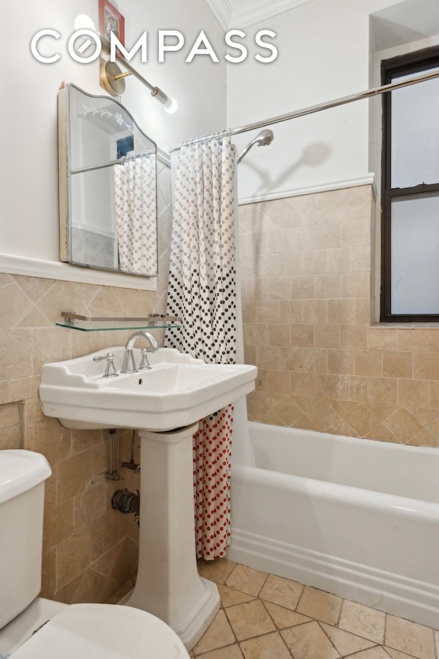 bathroom with tile patterned floors, shower / bath combination with curtain, toilet, and tile walls