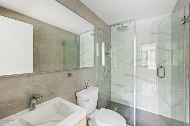 bathroom with tile walls, an enclosed shower, vanity, tasteful backsplash, and toilet