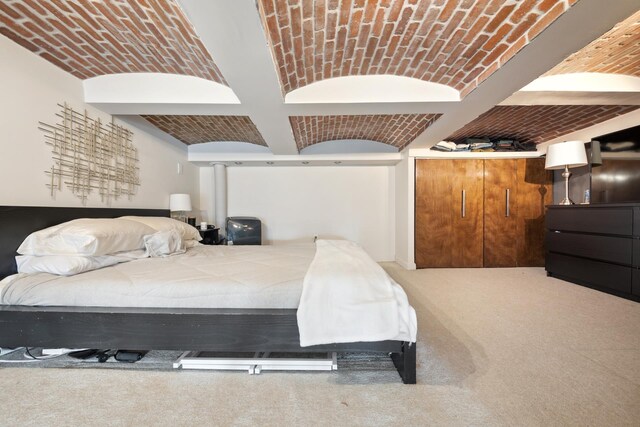 carpeted bedroom with brick ceiling