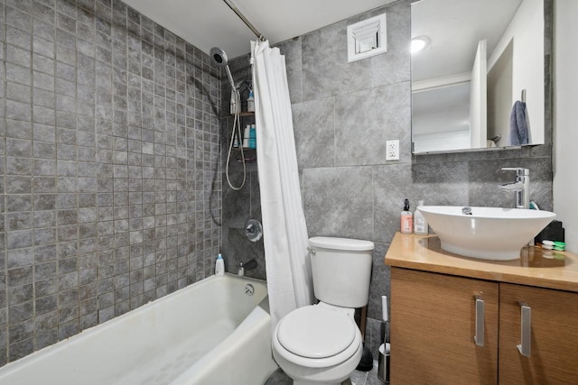 full bathroom featuring vanity, tasteful backsplash, tile walls, toilet, and shower / bath combo