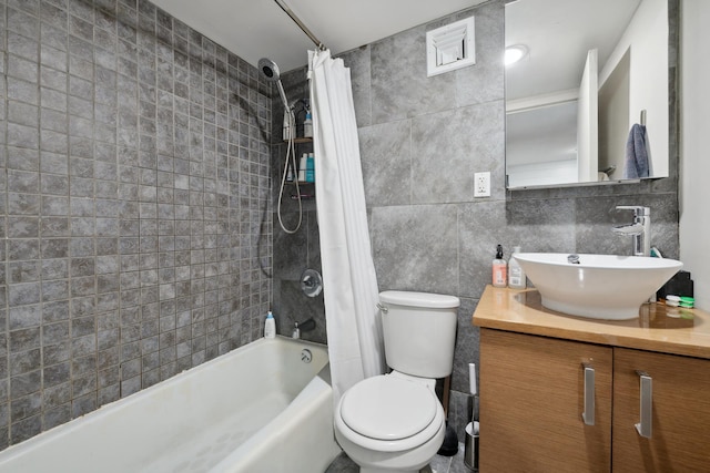 full bathroom featuring vanity, decorative backsplash, shower / tub combo, tile walls, and toilet