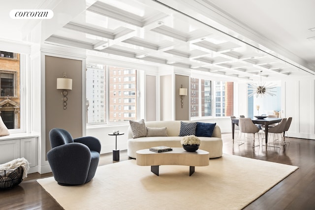 living room with coffered ceiling, beamed ceiling, dark hardwood / wood-style flooring, and a wealth of natural light