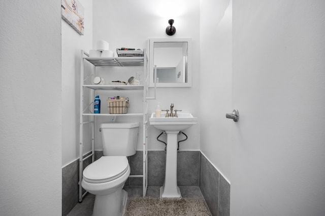 bathroom with toilet and tile patterned flooring