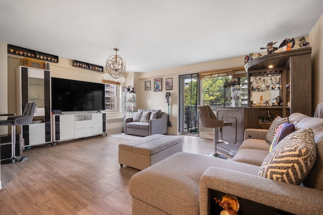 living room featuring a notable chandelier and wood finished floors