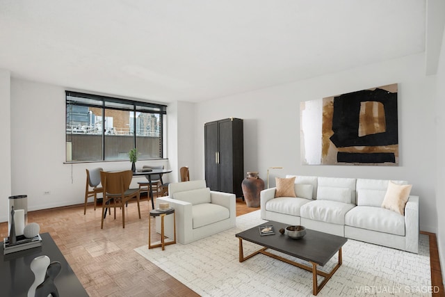 living area featuring baseboards