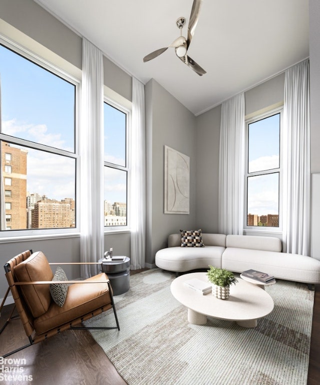 sitting room featuring wood-type flooring and ceiling fan