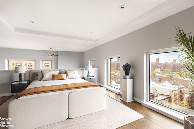 bedroom featuring a tray ceiling and hardwood / wood-style floors