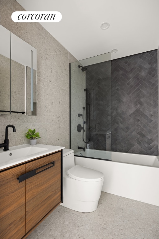 full bathroom featuring vanity, backsplash, tile walls, toilet, and combined bath / shower with glass door