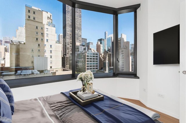 bedroom featuring light hardwood / wood-style floors and multiple windows