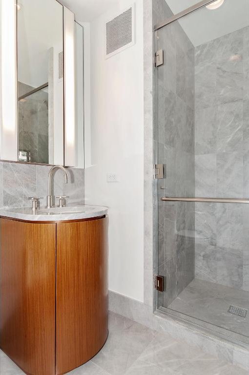 full bathroom featuring tile patterned floors, toilet, bathing tub / shower combination, tile walls, and vanity