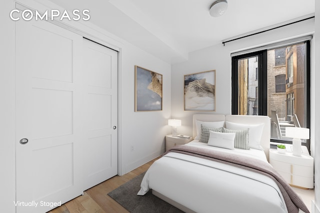 bedroom with baseboards and light wood-style floors