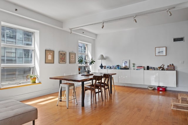 dining space featuring light hardwood / wood-style flooring and rail lighting