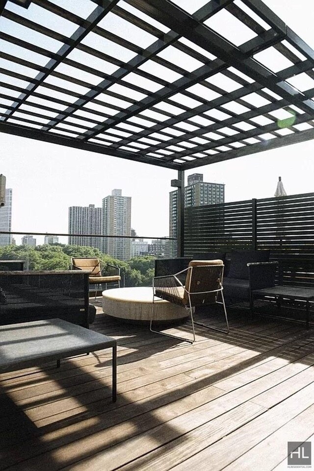 wooden deck featuring a pergola and a city view