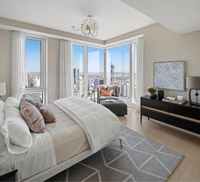 bedroom featuring hardwood / wood-style floors and a chandelier