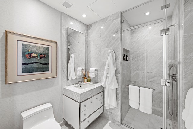 bathroom with a stall shower, visible vents, vanity, and toilet