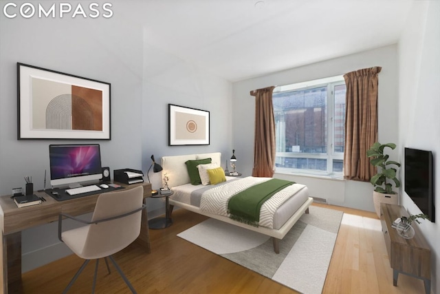 bedroom with multiple windows and wood-type flooring