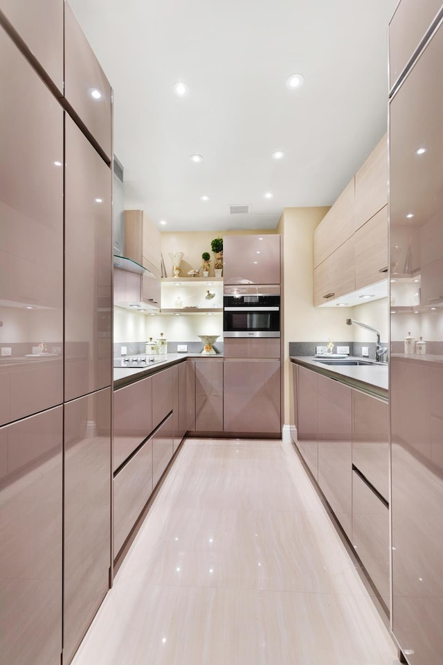 kitchen featuring light tile patterned flooring, oven, a sink, open shelves, and modern cabinets