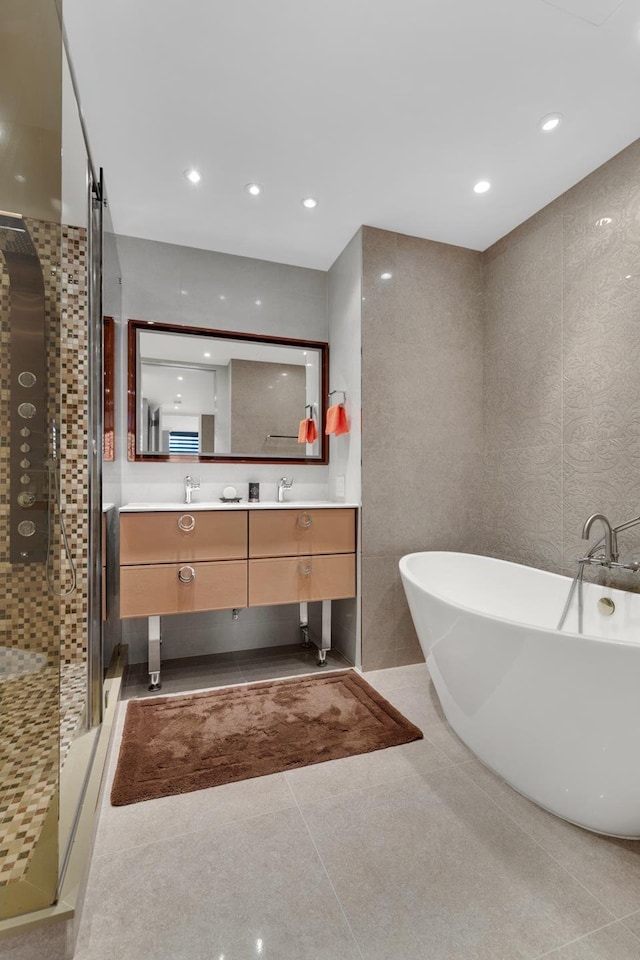 full bathroom with double vanity, recessed lighting, a freestanding tub, and a shower stall