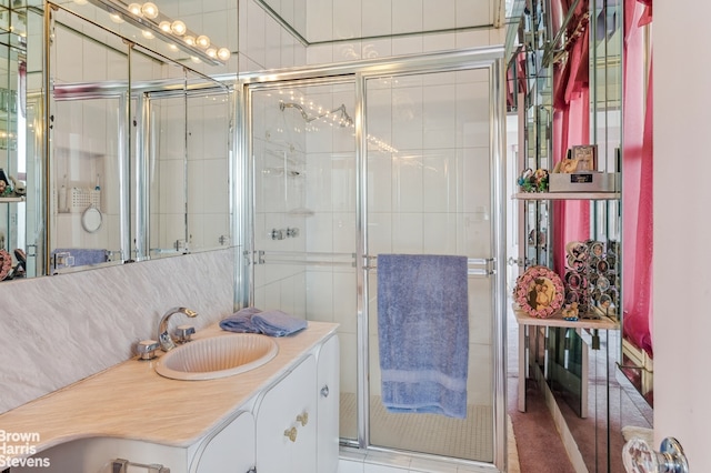 bathroom featuring walk in shower and vanity