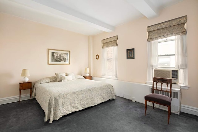 bedroom featuring beamed ceiling, radiator, multiple windows, and dark colored carpet