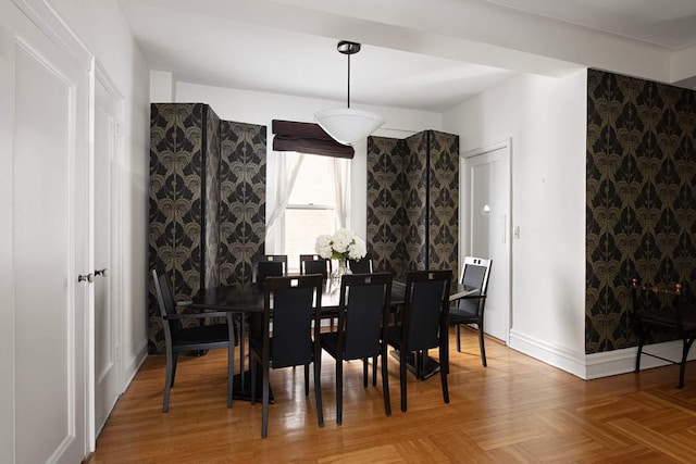 dining space featuring parquet flooring