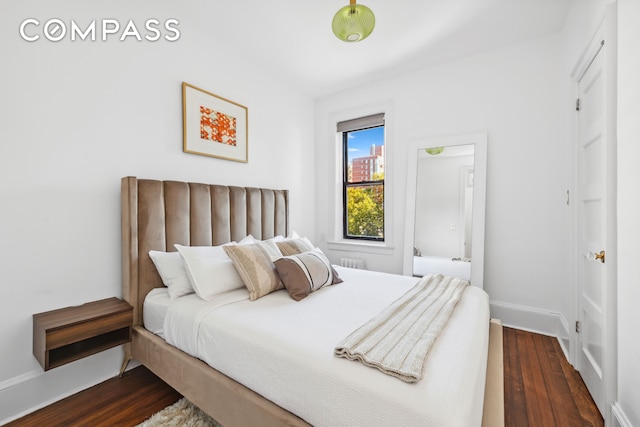 bedroom featuring dark wood finished floors and baseboards