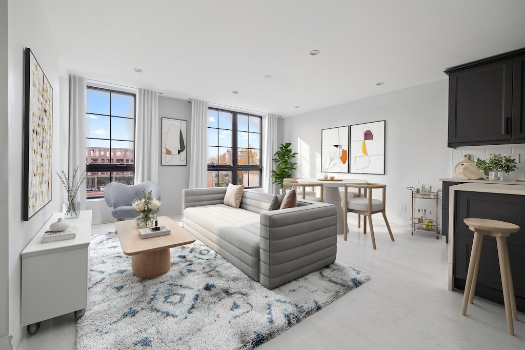 living room with recessed lighting, a healthy amount of sunlight, and light wood-style flooring