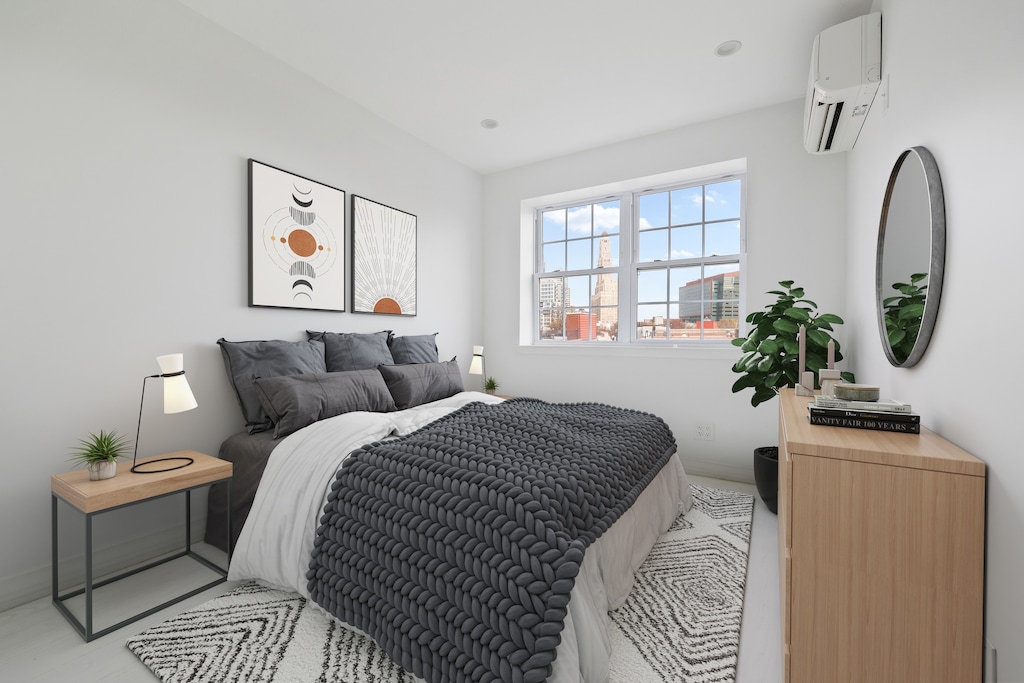 bedroom featuring a wall unit AC