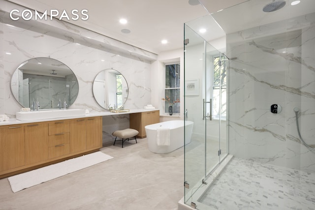 full bathroom with a soaking tub, a marble finish shower, vanity, and recessed lighting