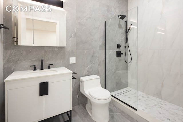 full bathroom with tile walls, toilet, vanity, and a marble finish shower