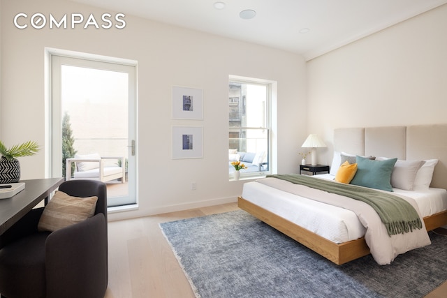 bedroom featuring wood finished floors and baseboards