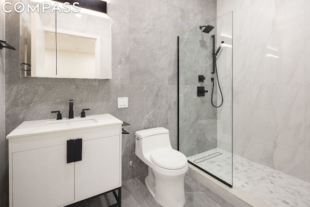 bathroom featuring tile walls, backsplash, vanity, tiled shower, and toilet