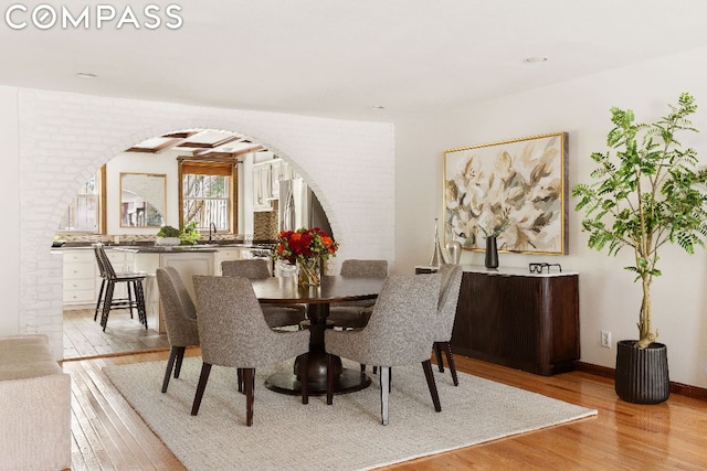 dining area featuring sink and light wood-type flooring