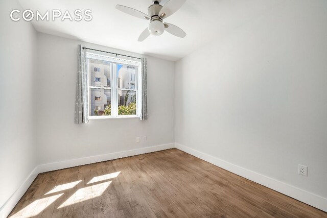 unfurnished room featuring light wood finished floors, a ceiling fan, and baseboards