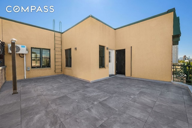 back of house featuring a patio area and stucco siding