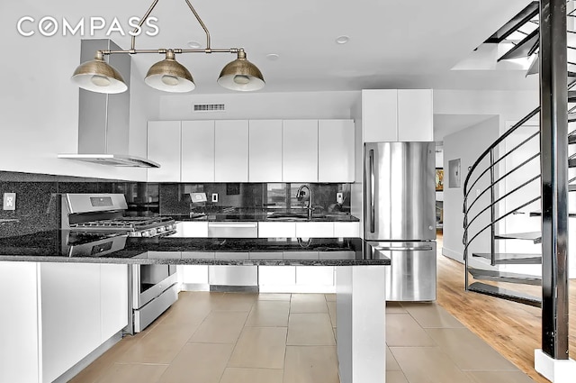 252 Richardson St Unit 3L, New York City, NY 11222 - kitchen featuring stainless steel appliances, white cabinetry, a sink, and backsplash